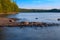 Long Exposure of Sunset at the Paijanne lake. Beautiful scape with stone beach, pine forest and water. Lake Paijanne