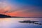 Long Exposure of Sunset at the Paijanne lake. Beautiful scape with stone beach, pine forest and water. Lake Paijanne, Finland