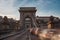 Long exposure in the sunshine. Cars drive fast over the Chain Bridge on the banks of the Danube in Budapest