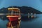 Long exposure teal and orange sunset view of Kotor Bay and a docked boat in postcard perfect town of Perast Montenegro