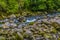 A long exposure view of a boulder strewn section of the white River in the jungle near Tortuguero in Costa Rica