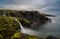 Long exposure view of the picturesque Irish coast and Dunseverick waterfall in summer