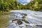 A long exposure view of turbulent water from Cenarth up the river Teifi, Wales after heavy rainfall