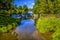 A long exposure view of two weirs across the River Alne at Wootton Wawen, Warwickshire, UK