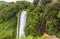 A long exposure view of the upper waterfalls at Marmore, Umbria, Italy dropping vertically amongst the lush greenery