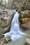 Long exposure waterfall falling down in the middle of the forrest in the mountains in republic of Adygea Russia