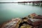 Long exposure winter dock and rocks