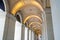 Long exterior portico of old Melbourne General Post Office Building with row of repeating illuminated arches