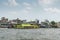 Long fast ferry painted in lemon yellow on Chao Phraya River, Bangkok Thailand