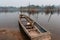 Long flooded wooden boat by river in Laos