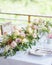 Long flower arrangements in the middle of the dining table.