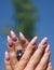 Long French nails with white manicure on a woman`s hand