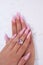 Long French nails with white manicure on a woman`s hand