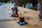 A long glass of black foamy coffee with a glasss coffee bottle on a wooden table. Concept