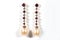 Long gold earrings with diamonds, rubies and pearls, on a white background