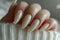 Long Gradient Ombre Acrylic Nails Demonstrated on a Neutral Background