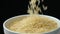 Long grain parboiled basmati rice pouring on black background, slow motion