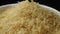 Long grain parboiled basmati rice pouring on black background, slow motion