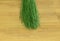 Long green plastic rods broom on the floor background.