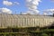 A long greenhouse under a cellophane film in the garden in the garden