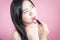 Long hair asian young beautiful woman lipstick, isolated over pink background. natural makeup, skincare, cosmetology and plastic.