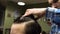 Long hair Barber cuts the hair of the client with scissors and comb in his barbershop