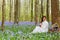 Long hair woman in bluebells forest