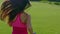 Long hair woman running in park. Back of running woman in slow motion