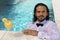 Long haired businessman wet inside the pool