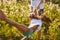 Long-haired girl swing, holding hands and feet