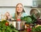 Long-haired housewife cooking at home kitchen