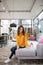 Long-haired pretty woman sitting on the cosy sofa