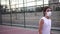 Long haired teenager dribbling and shooting the ball in basketball court