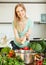 Long-haired woman adding spices to the pot