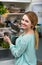 Long-haired woman arranging space in fridge at home