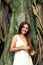 Long-haired woman near a banyan tree