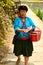 The long-haired woman of the Yao people sells souvenirs to tourists.