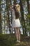 Long hairy women posture in coniferous forest