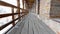 Long hallway in ancient castle. Wooden boards and bricks.