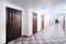 Long hallway with brown wooden doors