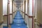Long hallway on the ship. Rows of cabin doors. Long corridor leading to rooms.