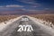 Long hard stony way concept: view on endless dirt road through dry desert with numbers of years 2021, 2022, 2023