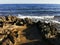 Long-hardened lava, porous, sharp coast of the Mediterranean Sea with oncoming waves against a skys