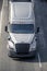 Long haul big rig semi truck tractor transporting semi truck driving on the road