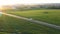 Long Haul Semi Truck Driving On Highway In Rural Hilly Region At Sunset Shine