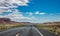 Long highway in the american desert, blue cloudy sky background