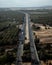 Long highway with cars surrounded by trees