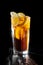 Long island ice tea. Standing on a varnished black table.