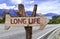 Long Life wooden sign with a street background