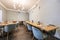 Long light wood dining table with green velvet upholstered stools in a bar dining